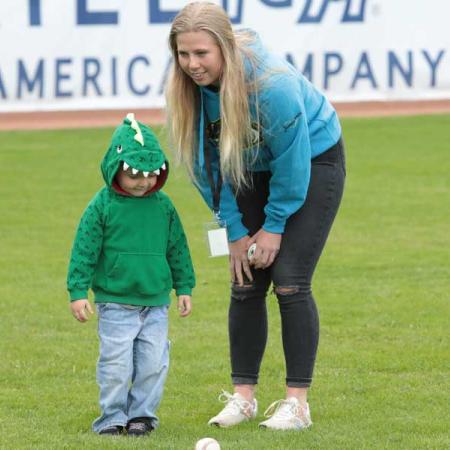 Ashton Beckerink with a child in a baseball field