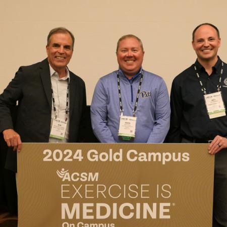 Mark Kelley accepting gold campus award for exercise science
