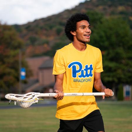 a student holding a lacrosse stick