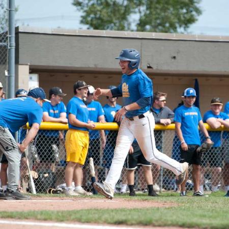 Baseball players high fiving on the bases