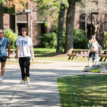 two students walking through the quad