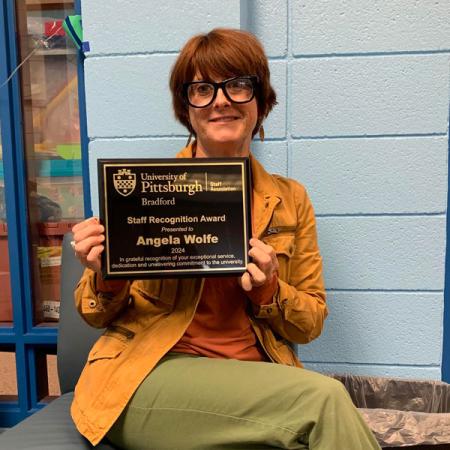Angie Wolfe holding her award