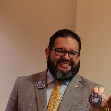 Luis smiling and holding a First-Gen pic