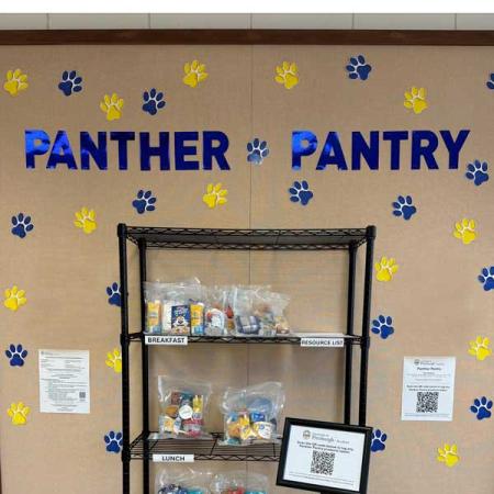 Shelves with food on them and a sign that says Panther Pantry