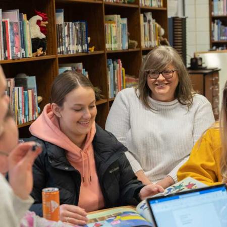 Students and professor working in the library