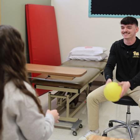 Logan working with an occupational therapist