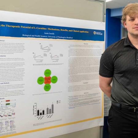 Justin Smulik with his research poster