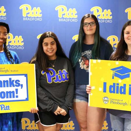 Students smiling for a graduation picture