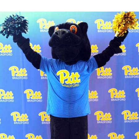 Panther mascot cheering with pom-poms in hands