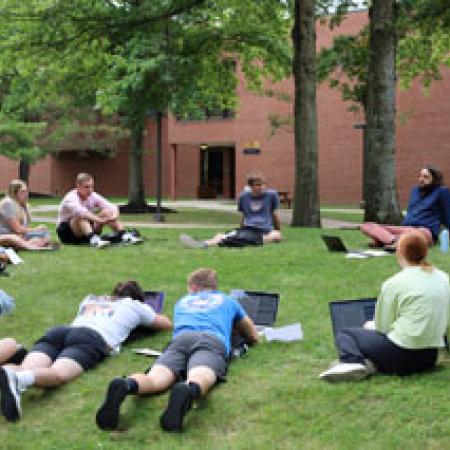 Students attending clas on the lawn in the campus quad