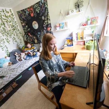 Student working at their desk in their dorm