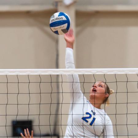 A girl about to spike a volleyball