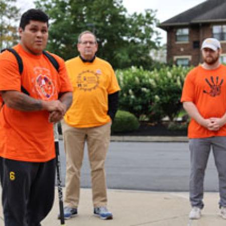 Tyrone Bowen-Collateta and members of Pitt-Bradford staff dressed in orange shirts